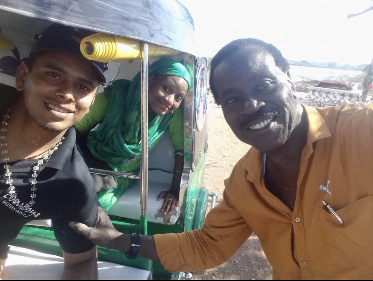Jazmin and Rafikbhai returning from field site with rickshaw driver Wasimbhai Makua.